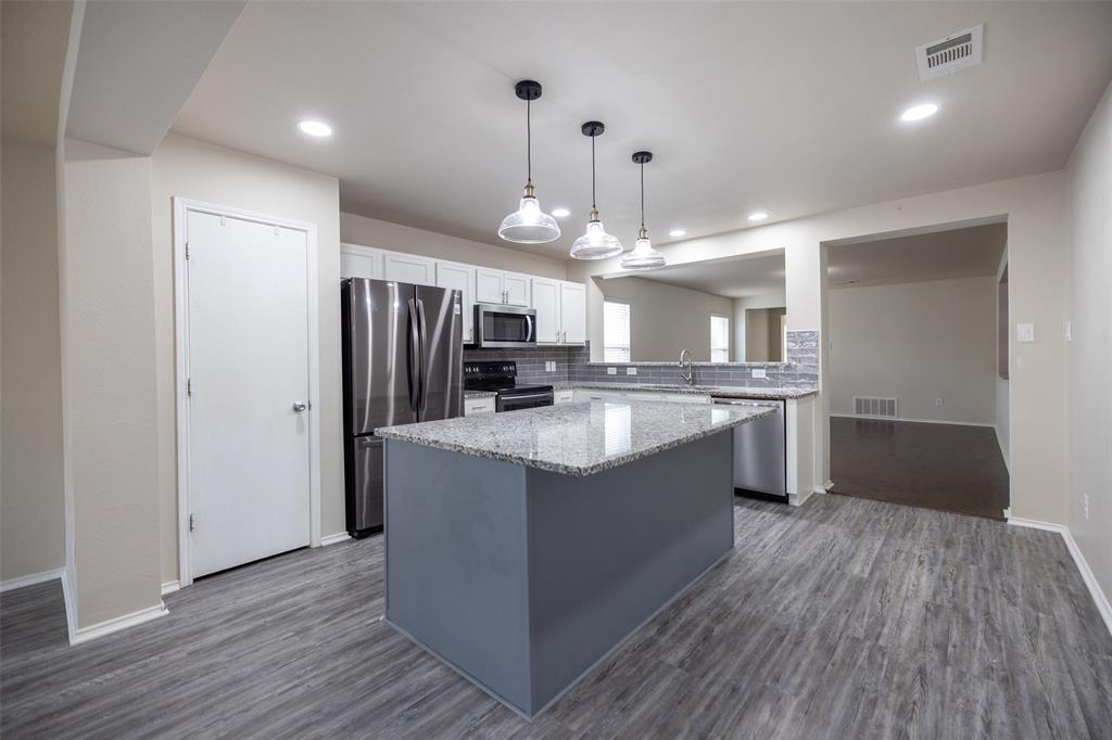 8805 Quarry Ridge Trail Fort Worth, TX 76244 - Photo 7 of 22 a large kitchen with granite countertop a large counter top a sink stainless steel appliances and cabinets