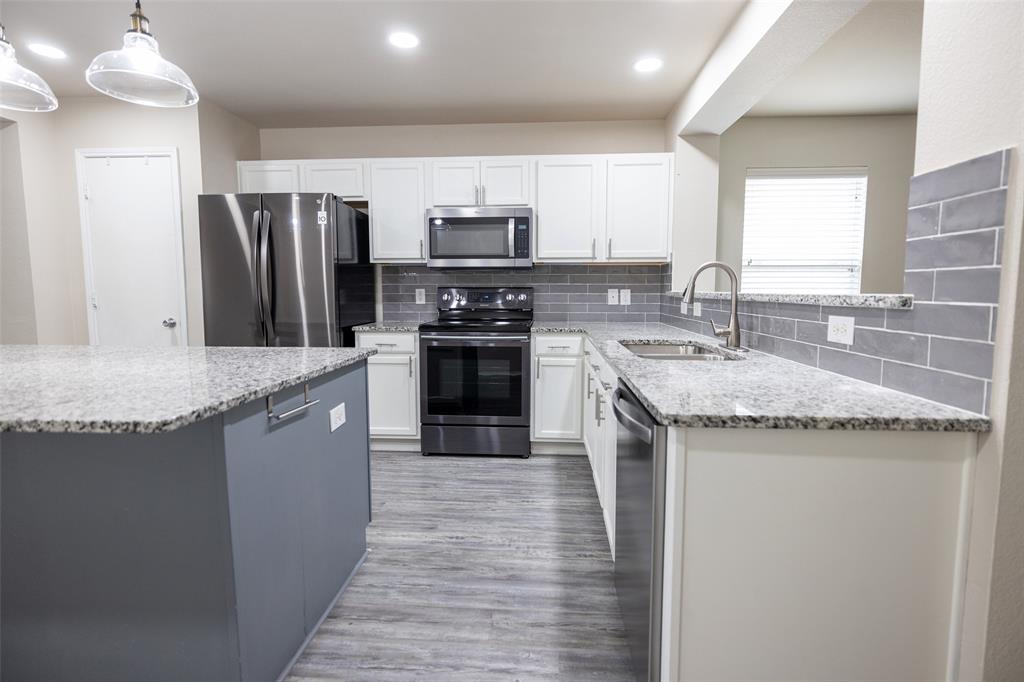 8805 Quarry Ridge Trail Fort Worth, TX 76244 - Photo 8 of 22 a kitchen with stainless steel appliances granite countertop a sink stove and refrigerator
