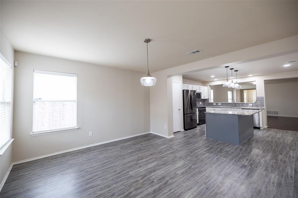 8805 Quarry Ridge Trail Fort Worth, TX 76244 - Photo 9 of 22 a view of a kitchen with a sink wooden floor and a window