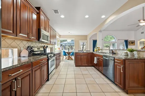 a kitchen with stainless steel appliances granite countertop a stove and a sink
