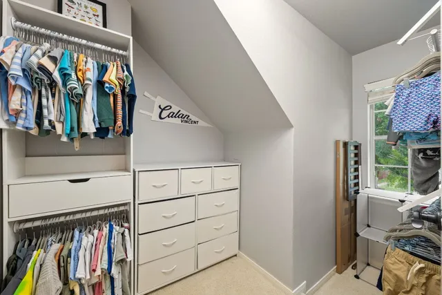 a bedroom with furniture and a lamp