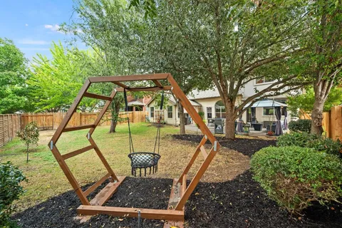 a kitchen with a dining table chairs and white cabinets