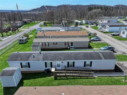 an aerial view of a house with a garden and a yard