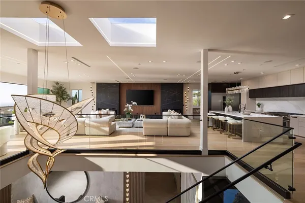 a bedroom with a bed and large windows with balcony view