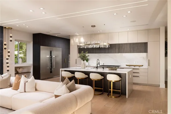 a kitchen with a table chairs stove and cabinets