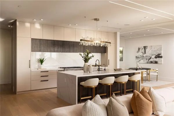 a kitchen with stainless steel appliances kitchen island granite countertop a stove and a sink