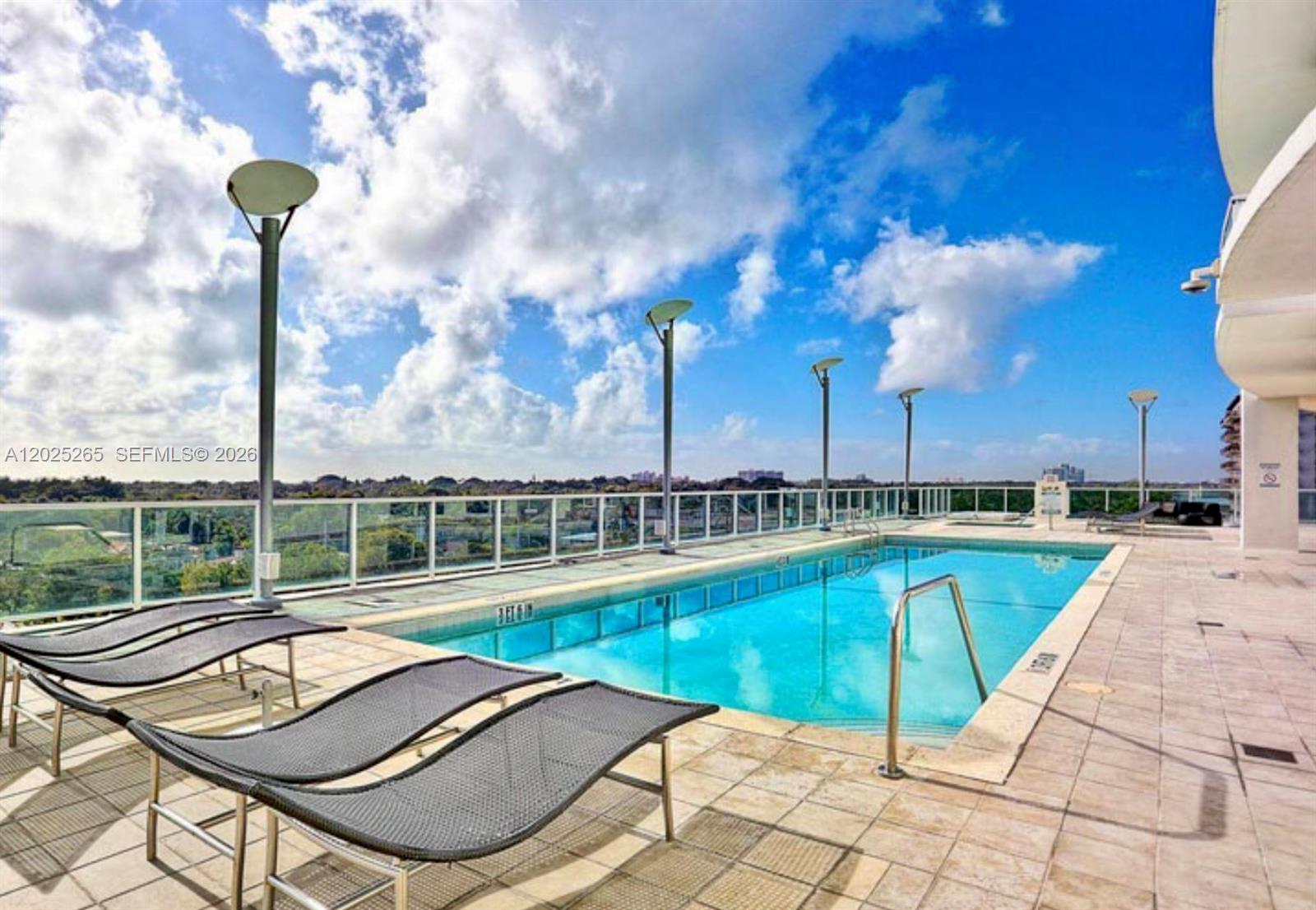 2525 Southwest 3rd Avenue, Unit 705 Miami, FL 33129 - Photo 19 of 26 a view of a swimming pool with a lounge chairs