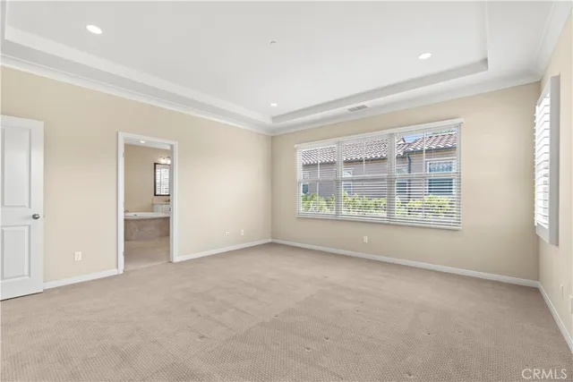 an empty room with windows and view of an empty room