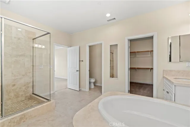 a spacious bathroom with a bathtub and a shower