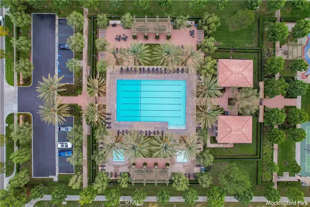 a view of a house with a yard and potted plants