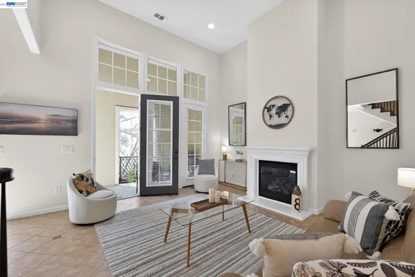 a living room with furniture fireplace and window