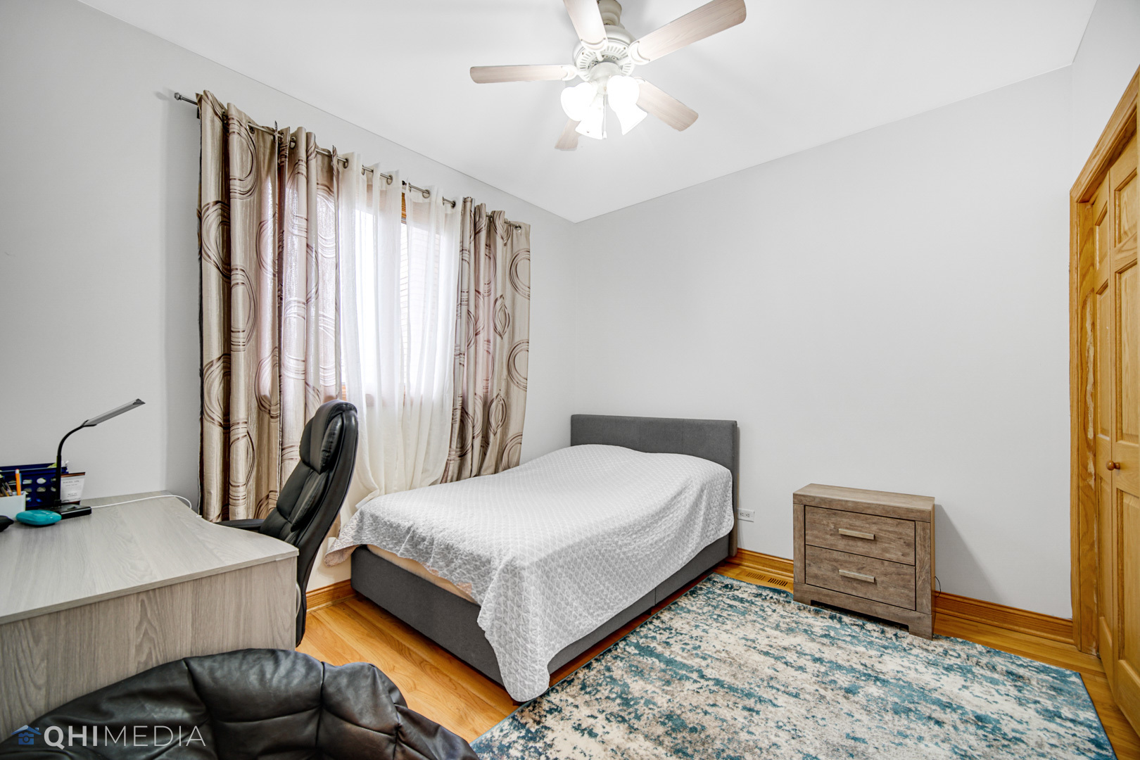 8832 South Roberts Road Hickory Hills, IL 60457 - Photo 11 of 16 a bedroom with a bed and a chandelier