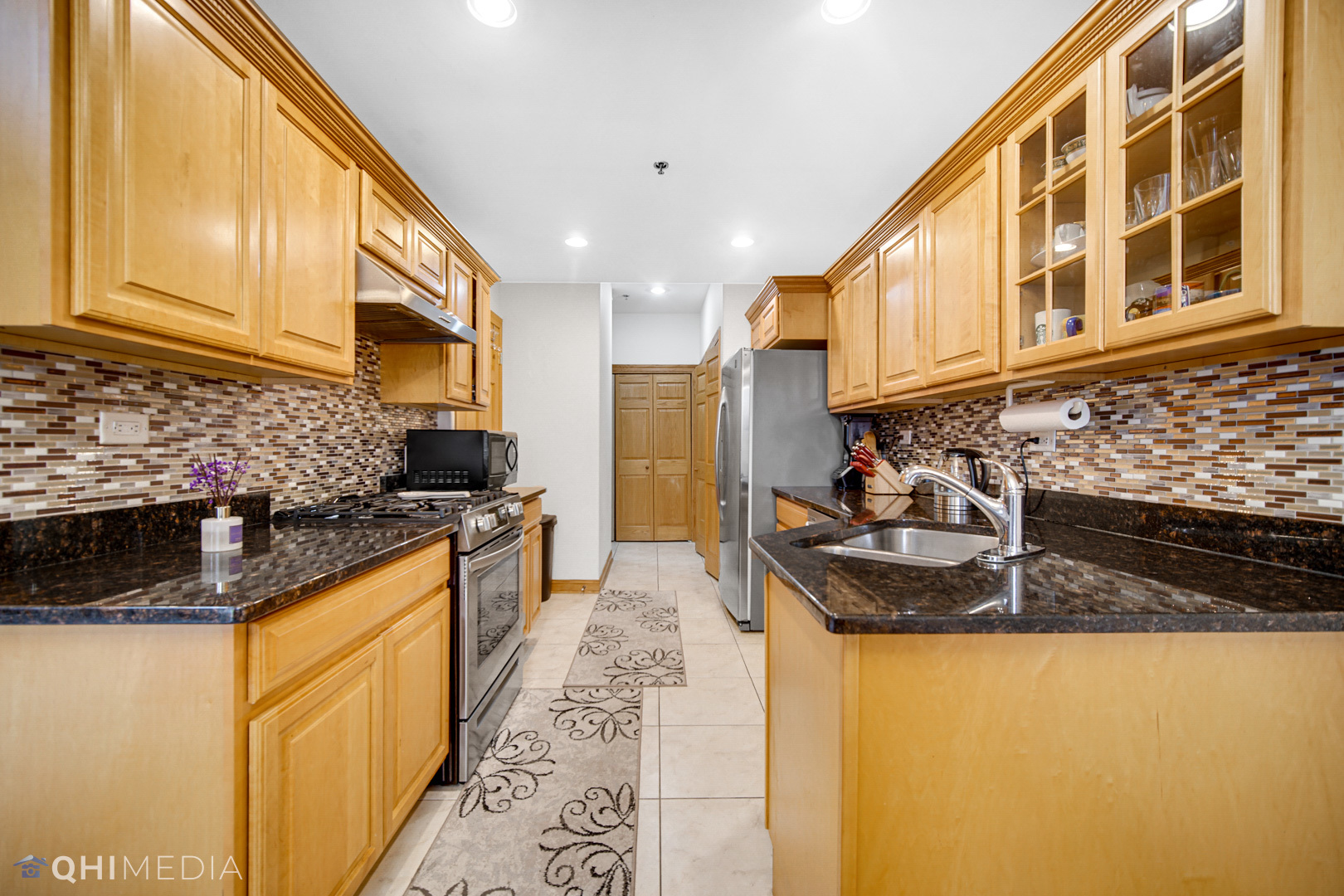 8832 South Roberts Road Hickory Hills, IL 60457 - Photo 2 of 16 a kitchen with sink a stove and cabinets
