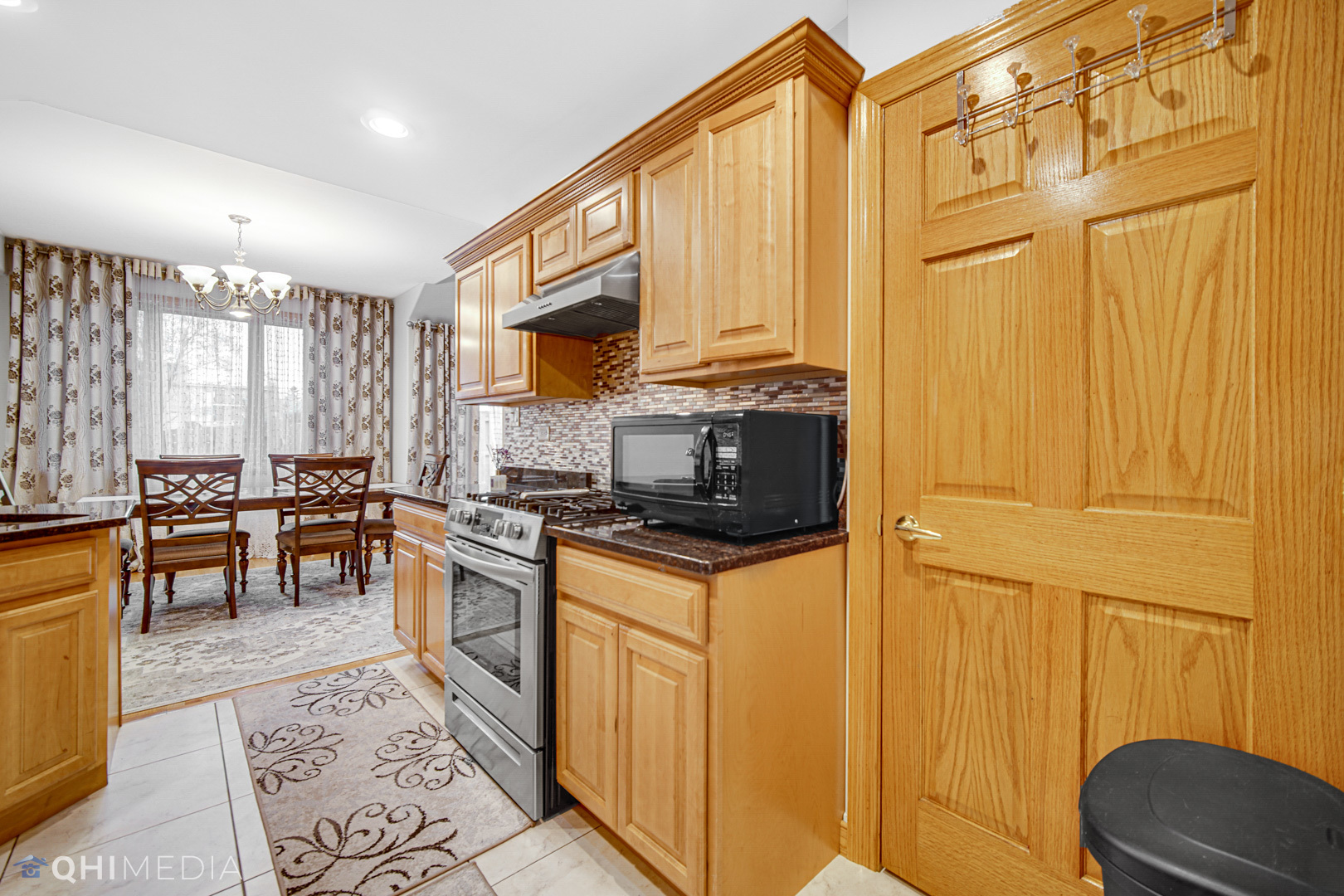 8832 South Roberts Road Hickory Hills, IL 60457 - Photo 3 of 16 a kitchen with stainless steel appliances granite countertop a stove top oven a sink and cabinets