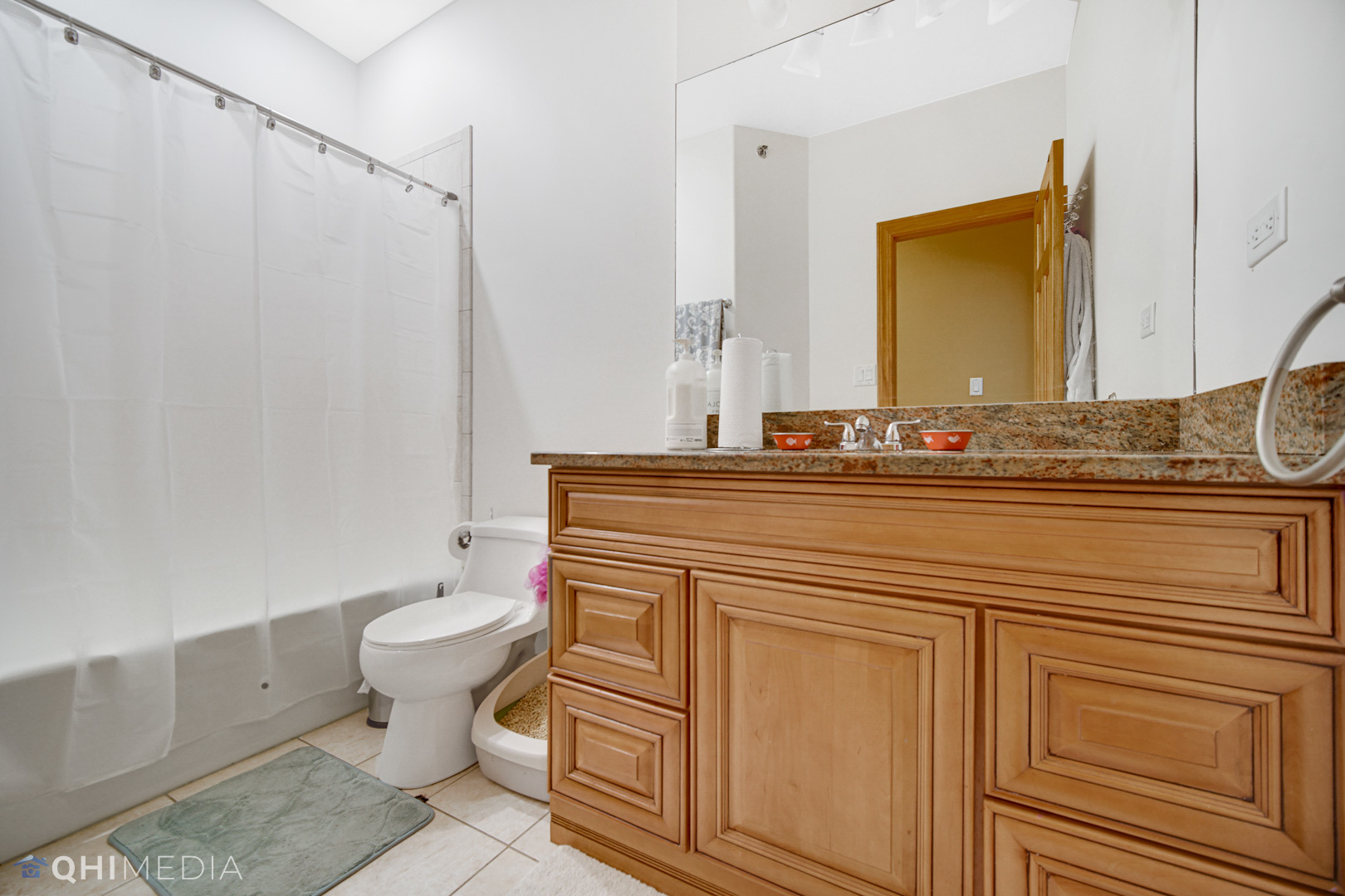 8832 South Roberts Road Hickory Hills, IL 60457 - Photo 9 of 16 a bathroom with a granite countertop toilet sink and mirror