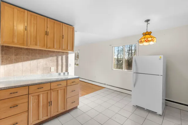 a kitchen with granite countertop white cabinets and white appliances