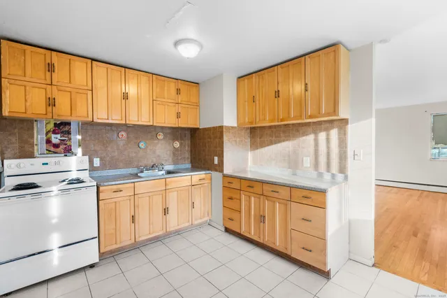 a kitchen with granite countertop cabinets stainless steel appliances and a sink