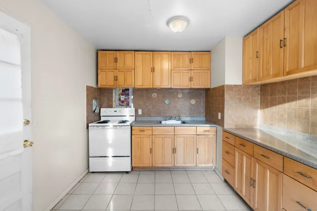 a kitchen with a stove a sink and a refrigerator