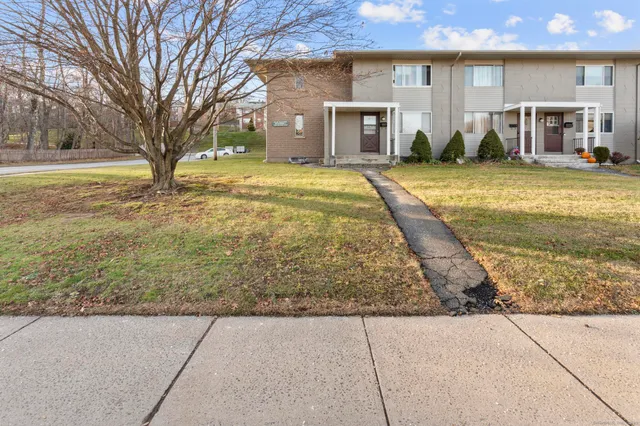 a view of a house with pool and yard
