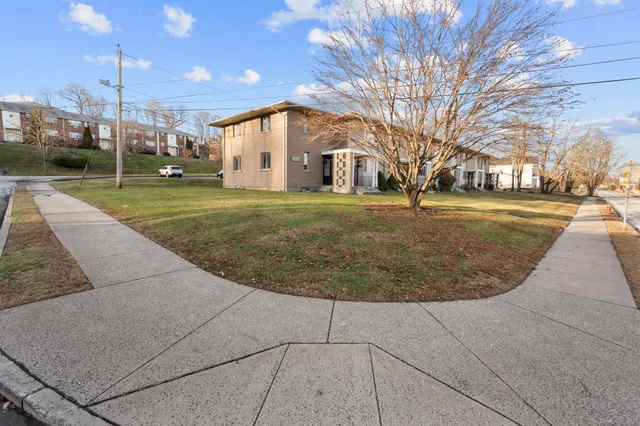 a view of a house with a backyard