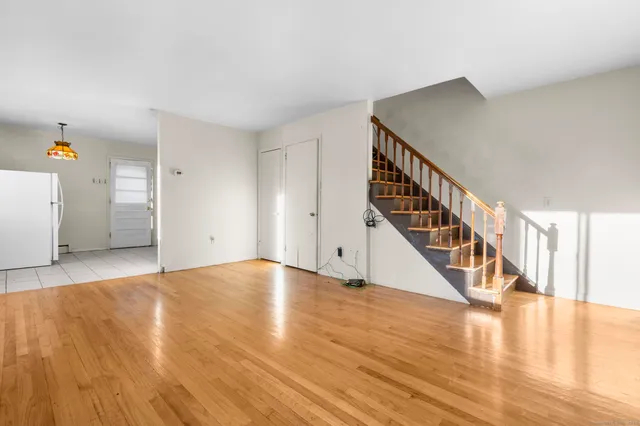 a view of an entryway with wooden floor