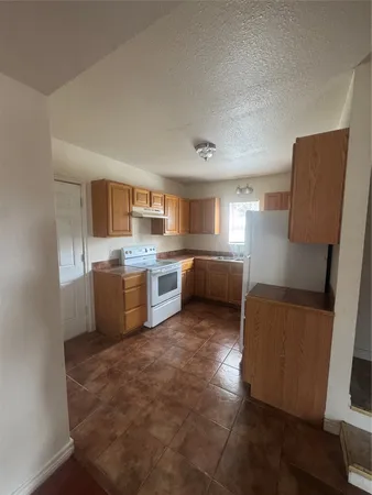 a kitchen with a cabinets and white appliances