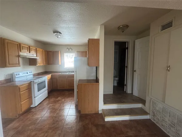 a kitchen with a refrigerator and a sink