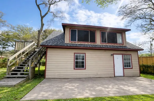 a house that has a tree in front of the house