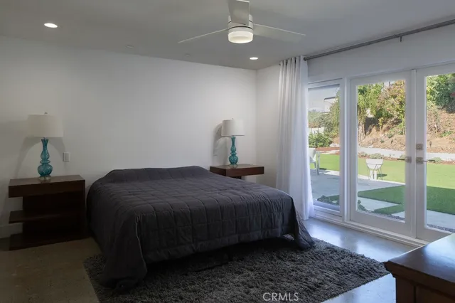 a bedroom with a bed lamps and window