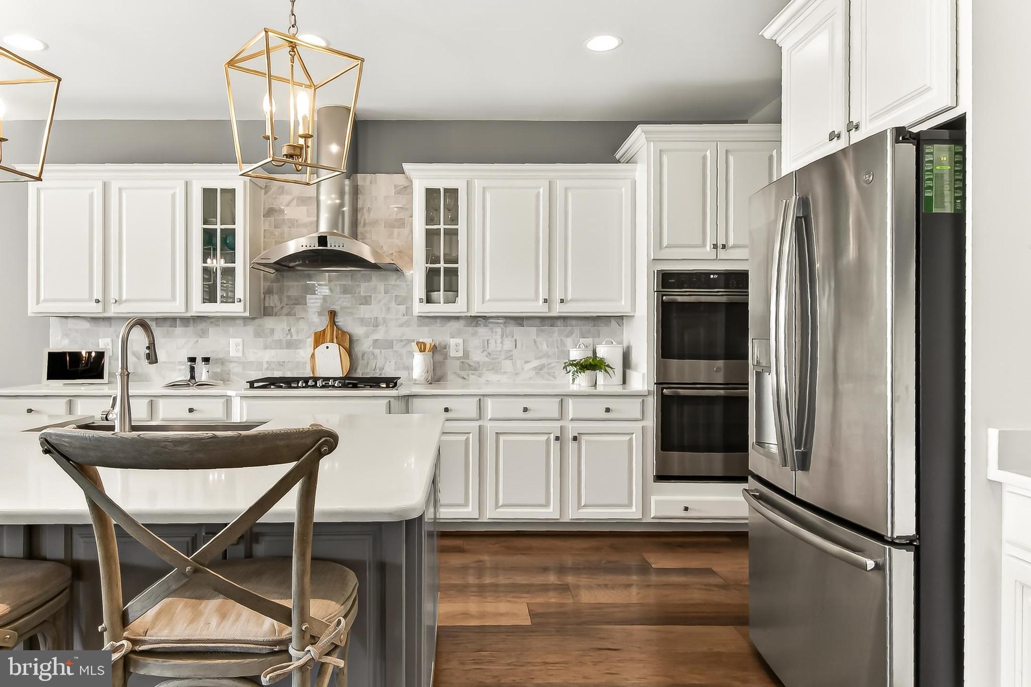 1103 Themis Street Southeast Leesburg, VA 20175 - Photo 24 of 108 a kitchen with stainless steel appliances granite countertop a refrigerator and a stove top oven