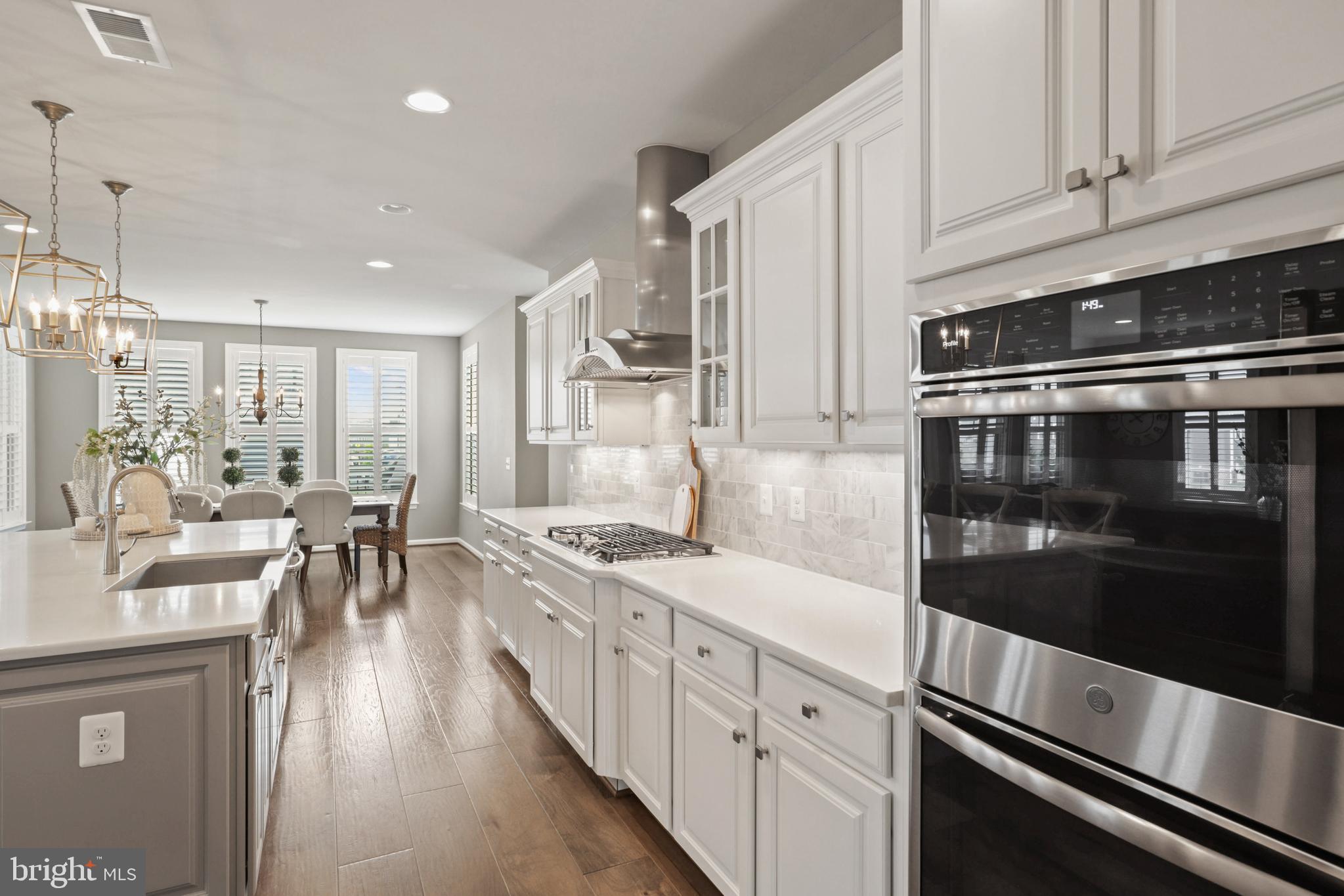 1103 Themis Street Southeast Leesburg, VA 20175 - Photo 26 of 108 a kitchen with stainless steel appliances kitchen island granite countertop a stove and white cabinets