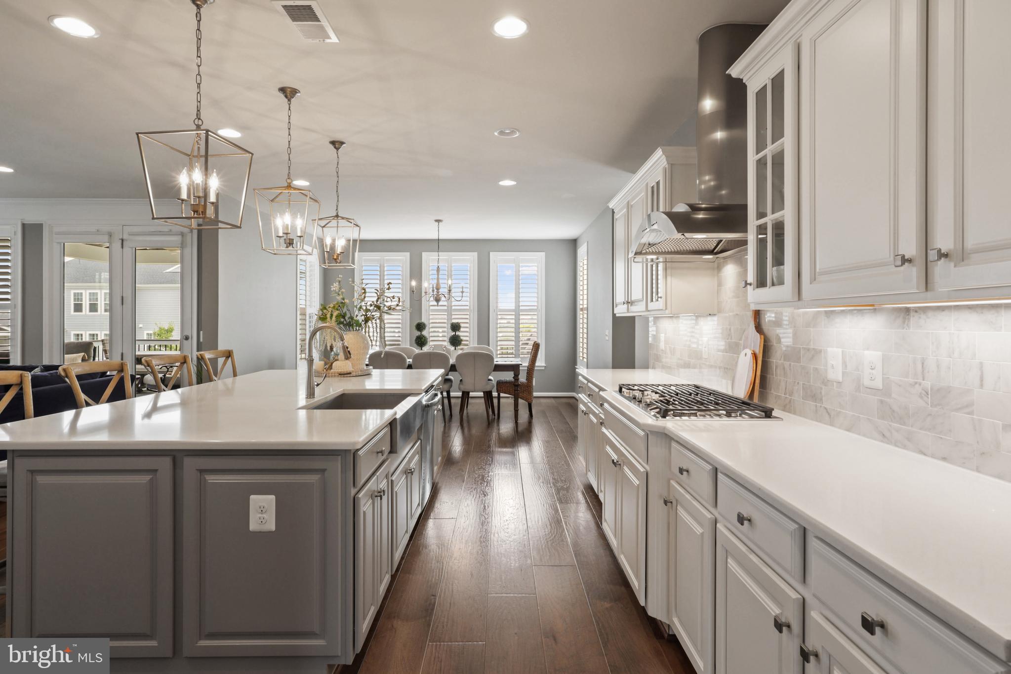 1103 Themis Street Southeast Leesburg, VA 20175 - Photo 27 of 108 a kitchen with counter top space a sink stainless steel appliances and cabinets