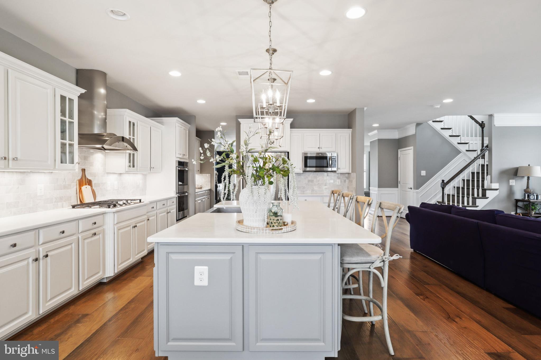 1103 Themis Street Southeast Leesburg, VA 20175 - Photo 28 of 108 a kitchen with stainless steel appliances kitchen island granite countertop a sink stove and cabinets