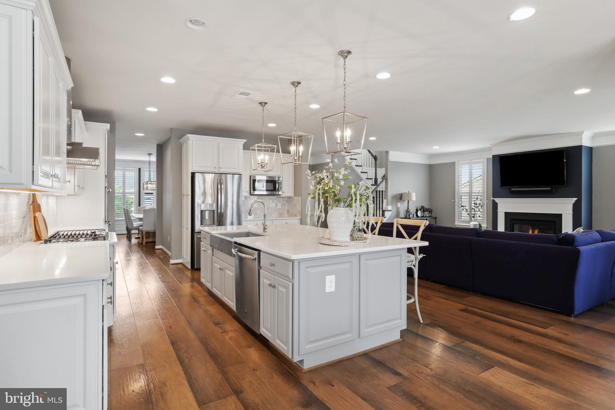 1103 Themis Street Southeast Leesburg, VA 20175 - Photo 29 of 108 a large kitchen with stainless steel appliances granite countertop a stove and a wooden floors