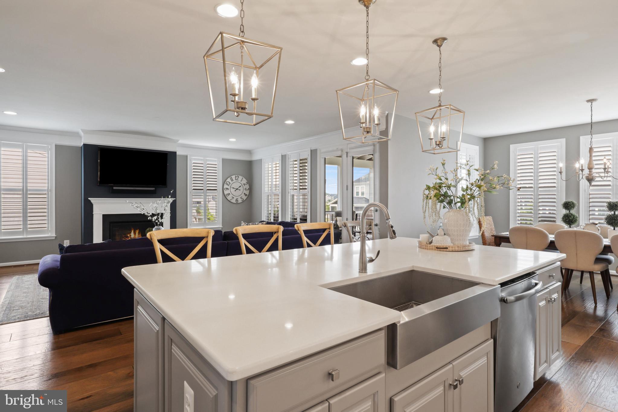 1103 Themis Street Southeast Leesburg, VA 20175 - Photo 36 of 108 a large white kitchen with a dining table chairs and couches