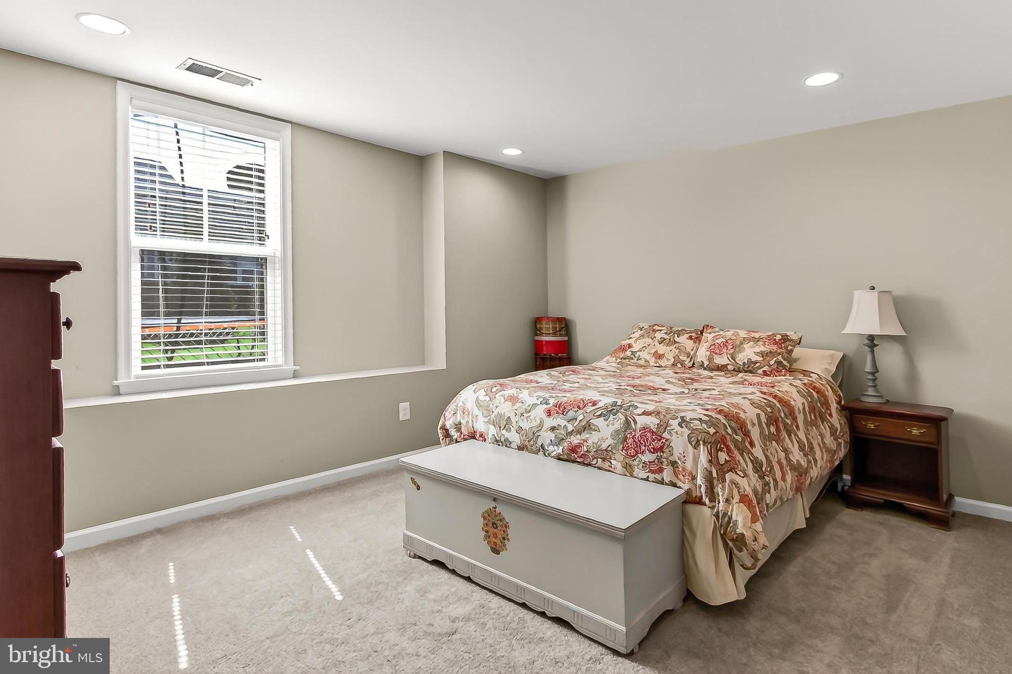 1103 Themis Street Southeast Leesburg, VA 20175 - Photo 77 of 108 a bed sitting in a bedroom next to a window