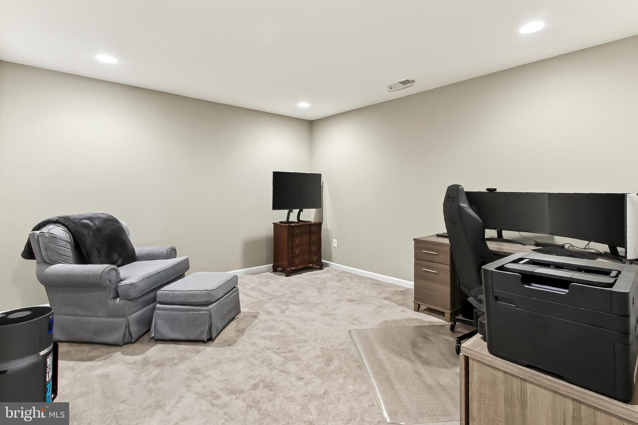 1103 Themis Street Southeast Leesburg, VA 20175 - Photo 79 of 108 a living room with furniture and a flat screen tv