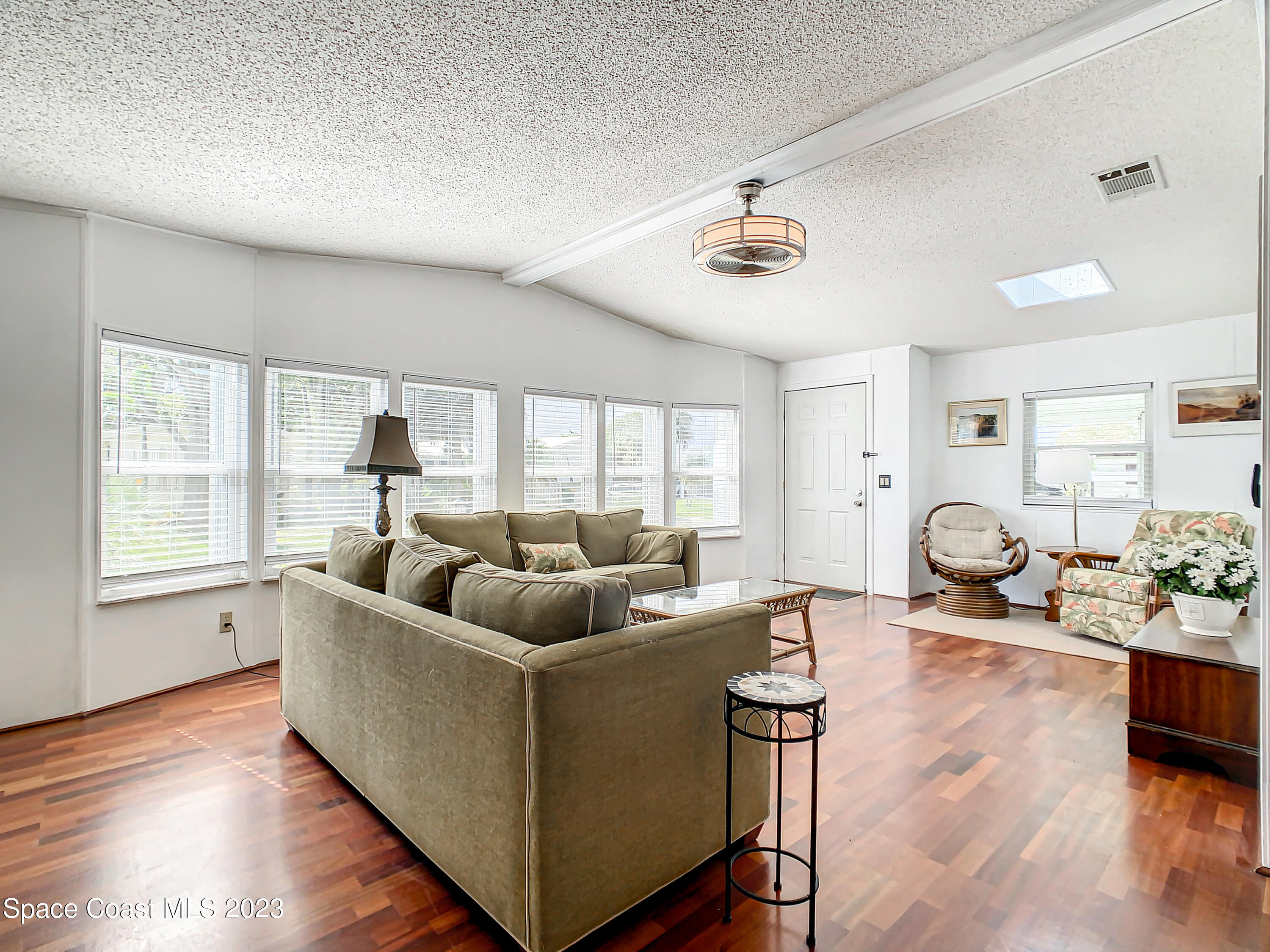 832 Periwinkle Circle Sebastian, FL 32976 - Photo 11 of 52 a living room with furniture and wooden floor