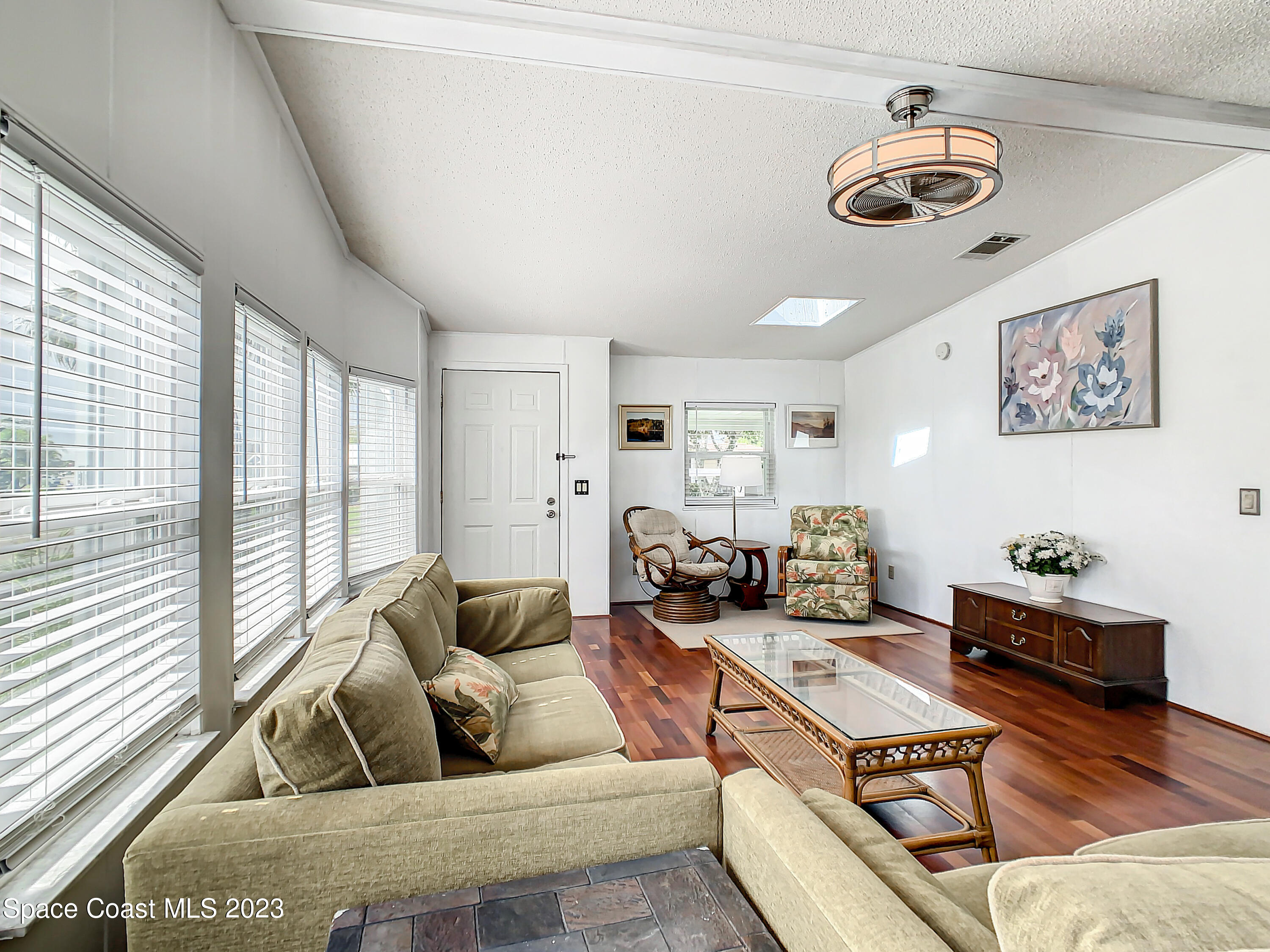 832 Periwinkle Circle Sebastian, FL 32976 - Photo 12 of 52 a living room with furniture gym equipment and a large window