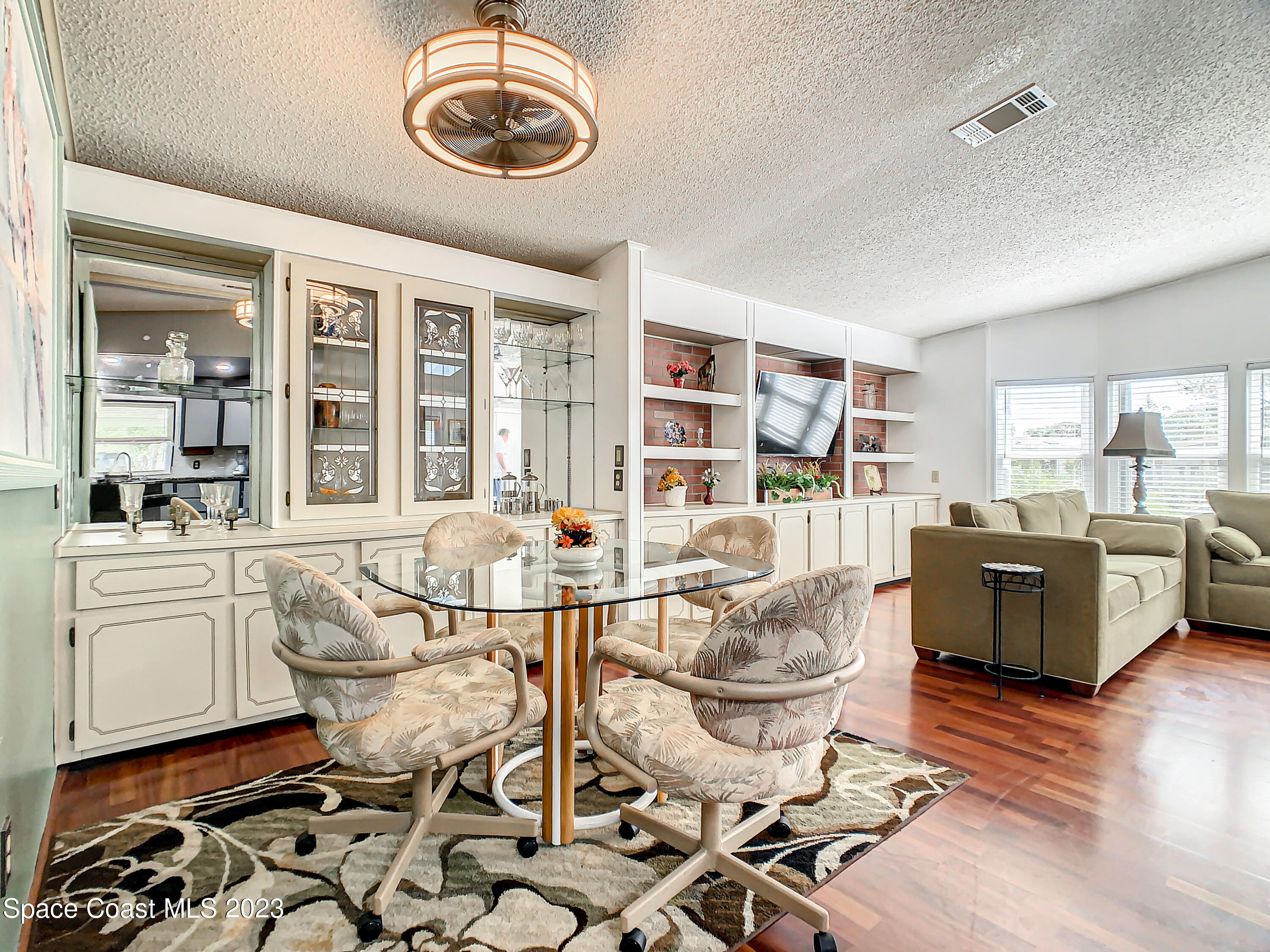 832 Periwinkle Circle Sebastian, FL 32976 - Photo 13 of 52 a view of a dining room with furniture and wooden floor