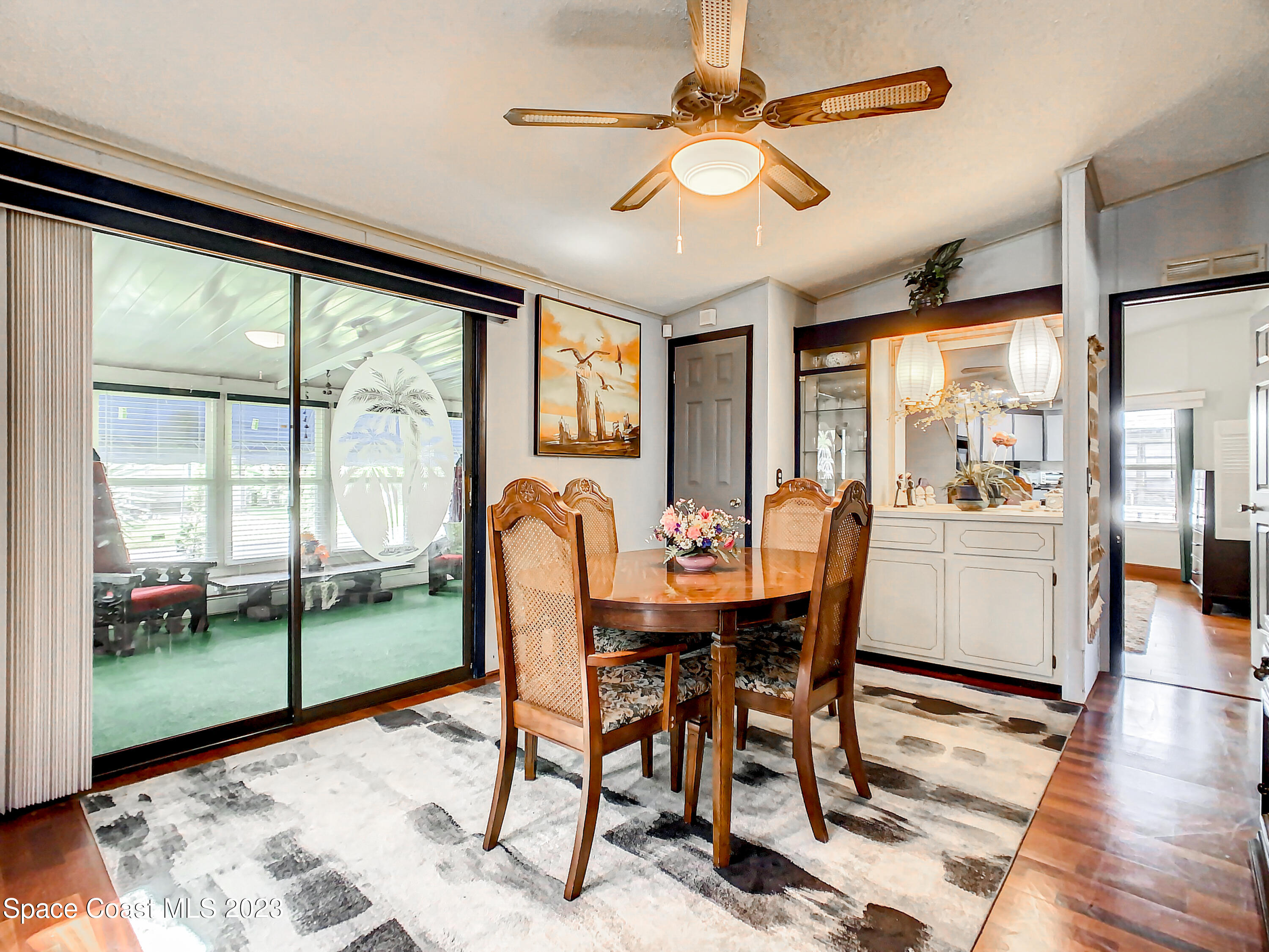832 Periwinkle Circle Sebastian, FL 32976 - Photo 20 of 52 a dining room with furniture a chandelier and wooden floor