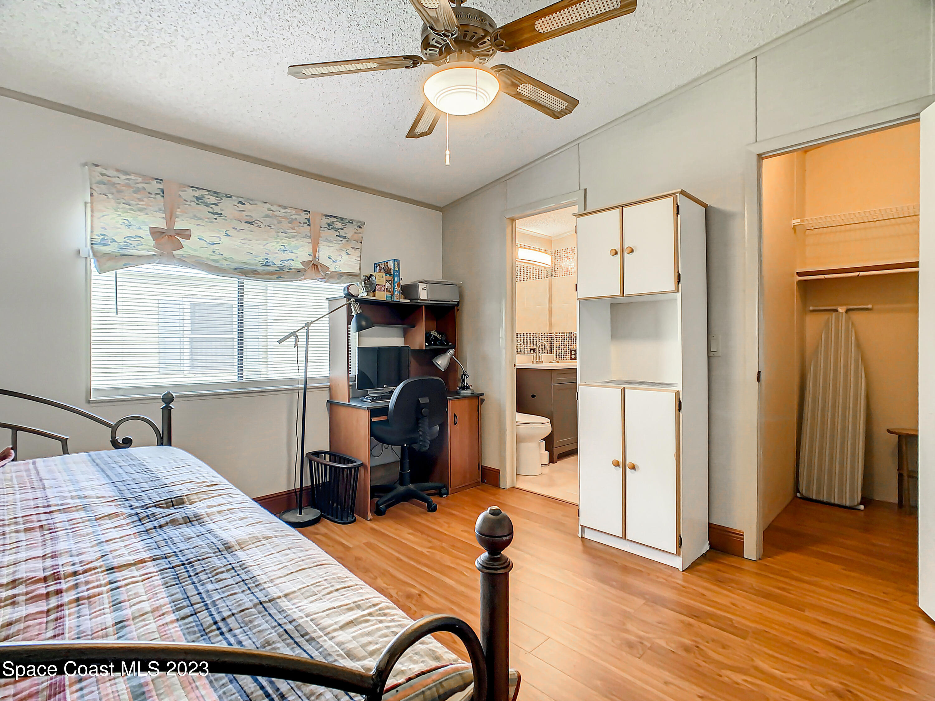 832 Periwinkle Circle Sebastian, FL 32976 - Photo 21 of 52 a bedroom with a bed and wooden floor