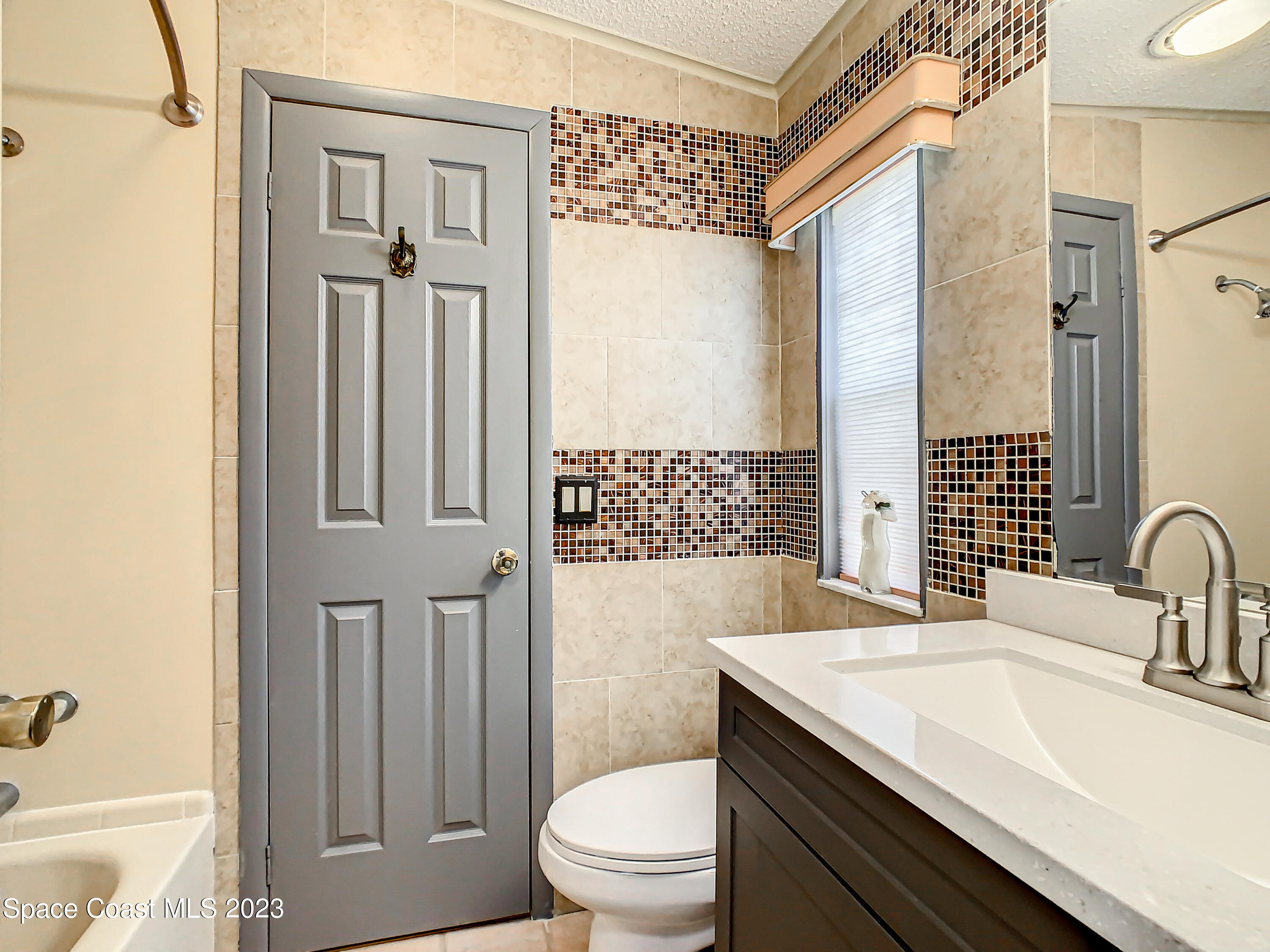 832 Periwinkle Circle Sebastian, FL 32976 - Photo 24 of 52 a bathroom with a sink a toilet and shower