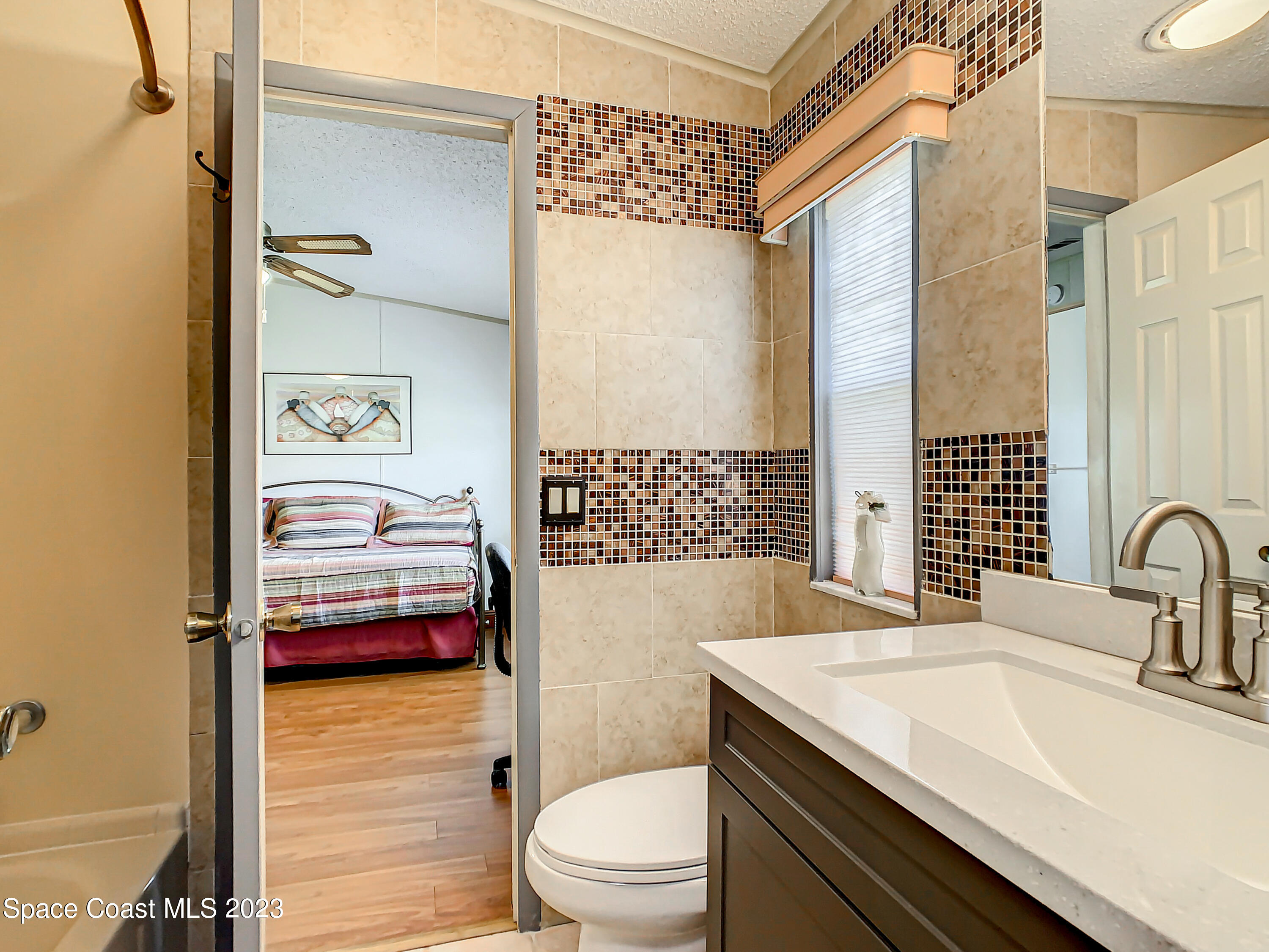 832 Periwinkle Circle Sebastian, FL 32976 - Photo 25 of 52 a bathroom with a sink a toilet and shower