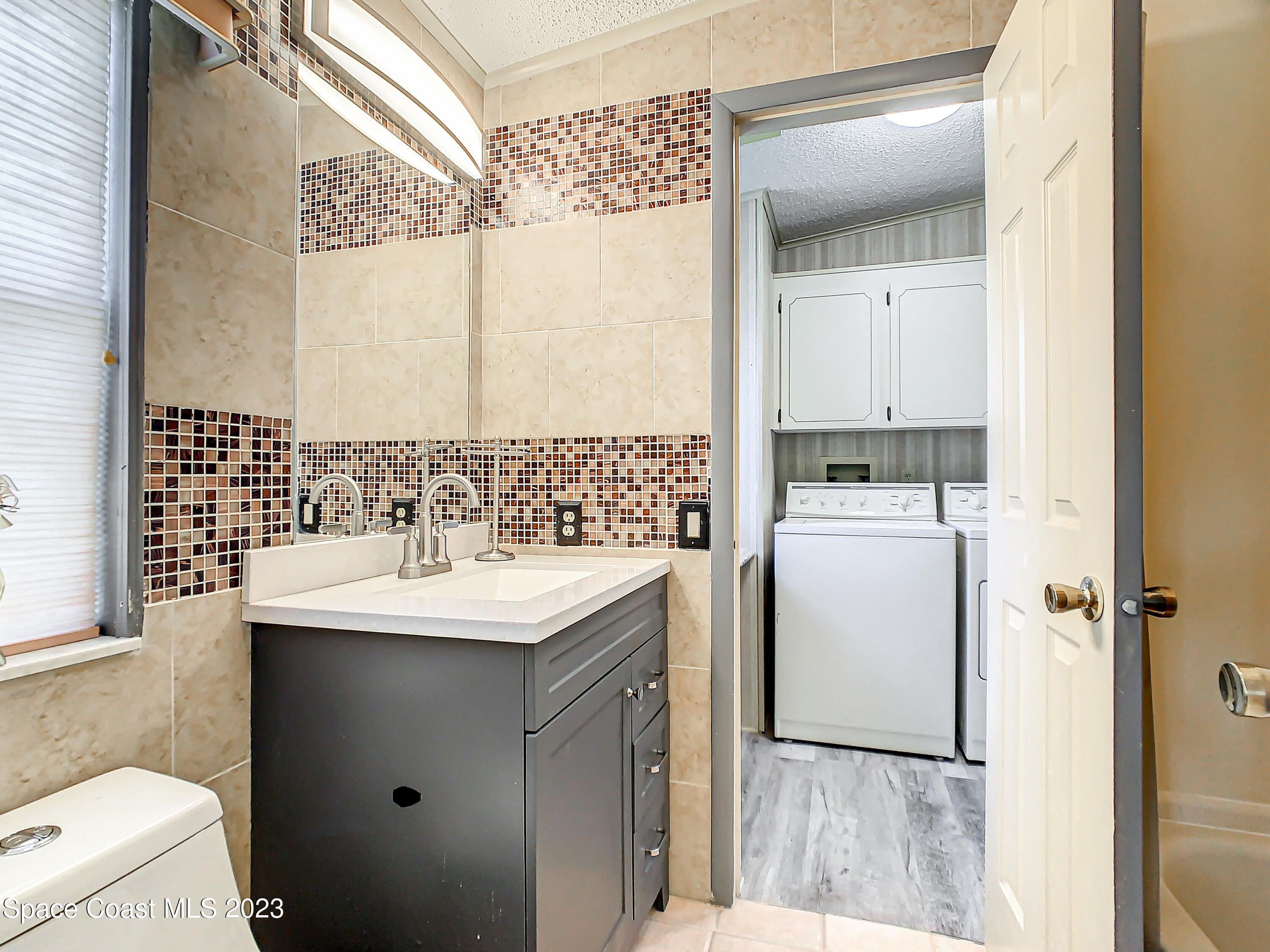 832 Periwinkle Circle Sebastian, FL 32976 - Photo 26 of 52 a bathroom with a sink toilet and shower