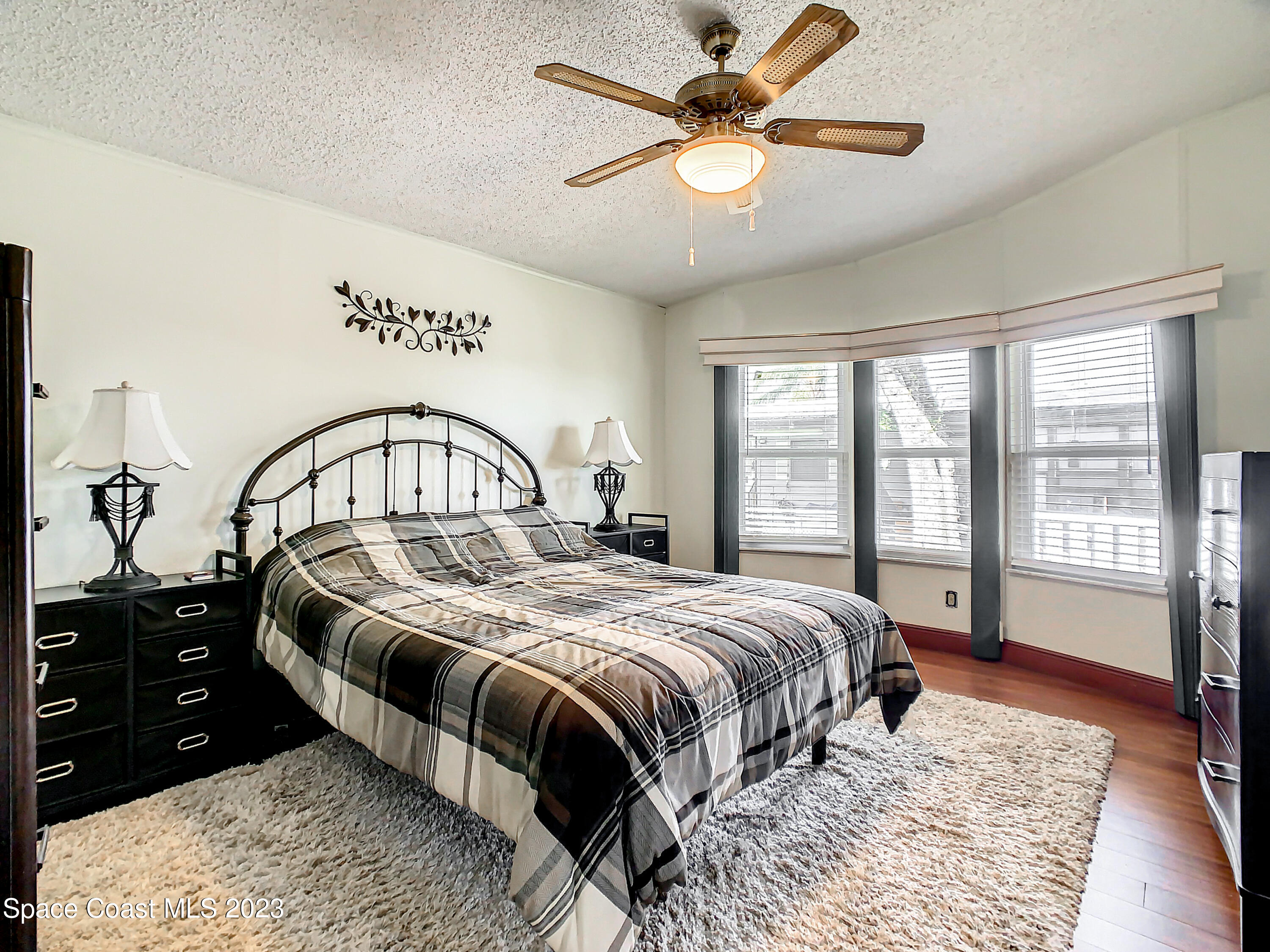 832 Periwinkle Circle Sebastian, FL 32976 - Photo 28 of 52 a bedroom with a large bed and a large window