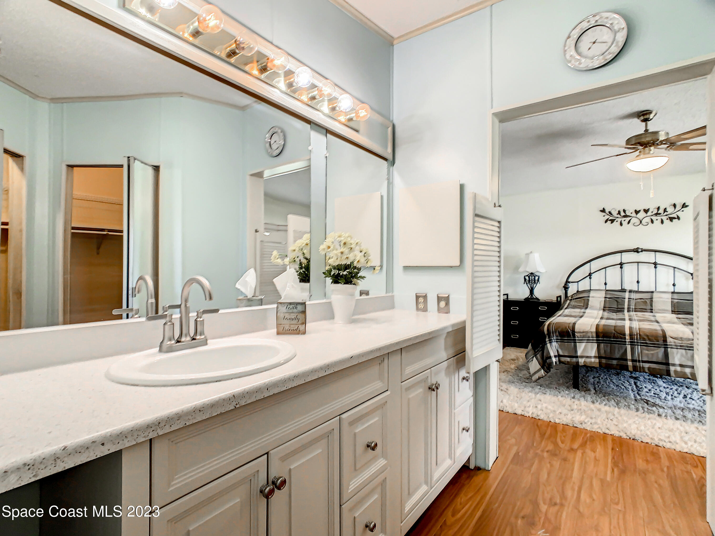 832 Periwinkle Circle Sebastian, FL 32976 - Photo 33 of 52 a en suite bathroom with a double vanity sink and a mirror