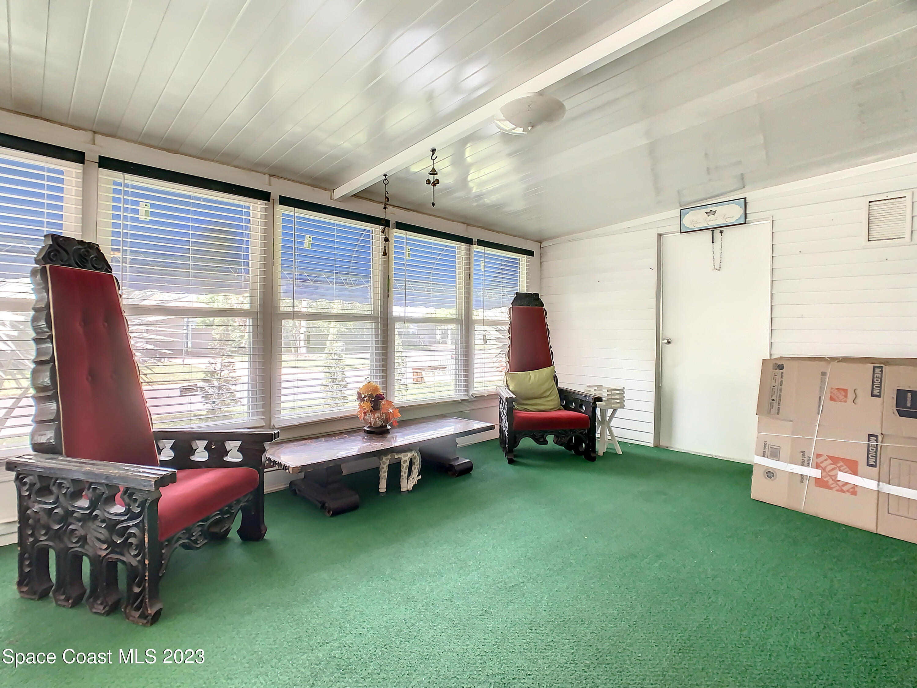 832 Periwinkle Circle Sebastian, FL 32976 - Photo 35 of 52 a living room with furniture and a large window