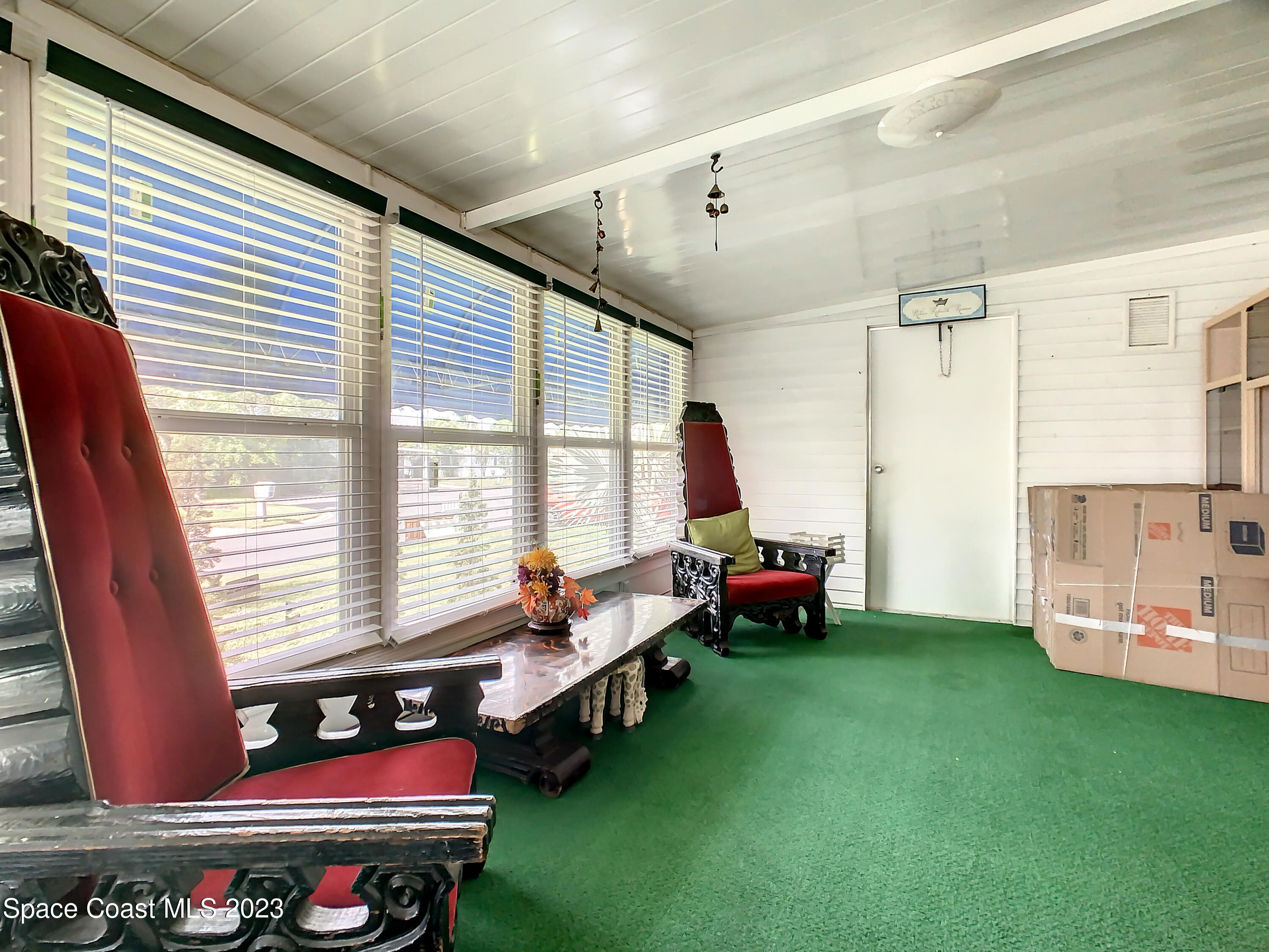 832 Periwinkle Circle Sebastian, FL 32976 - Photo 38 of 52 a living room filled with furniture and large windows