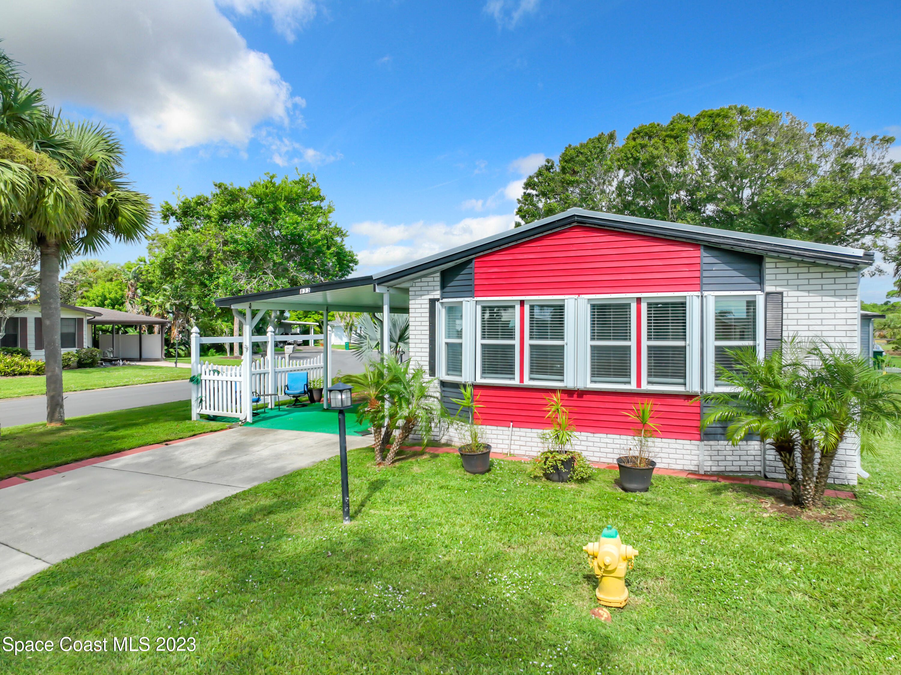 832 Periwinkle Circle Sebastian, FL 32976 - Photo 42 of 52 a view of pool with table and chairs under an umbrella